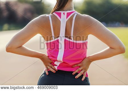The Back Of A Girl In A Sports Wardrobe. A Photo Of The Back Of A Handsome Girl In A Pink Fitness T-