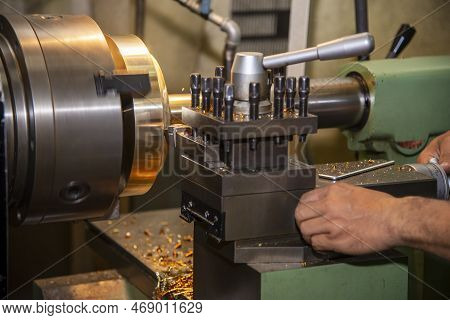 The Machine Operator Working With Lathe Machine. The Metalworking Process By Turning Machine.