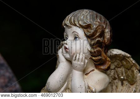 Small Putto With Wings On A Grave  Looks Dreamily