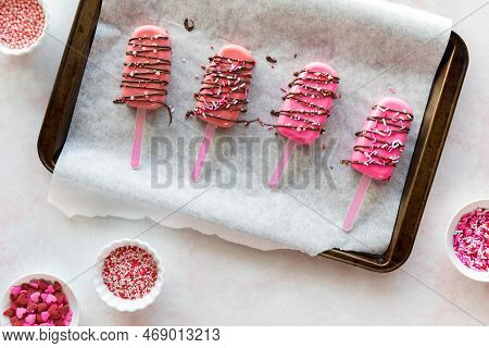 Homemade Cakesicles Drizzled With Candy Melts And Decorated With Sprinkles.