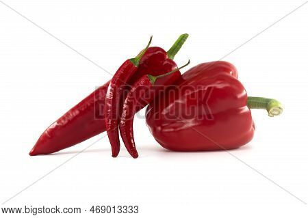 A Stack Of Fresh Chili Peppers And Red Bell Peppers Isolated On White Background