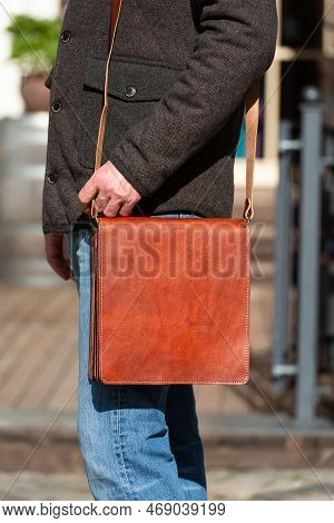 Close-up Photo Of Light Brown Messanger Leather Bag On Mans Shoulder