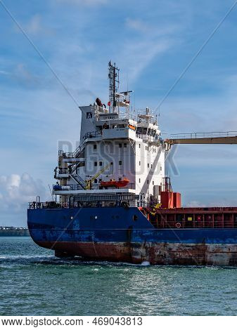Cobh, Ireland, August 10, 2022. An Old Rusty Big Ship Is Sailing On The Sea Under A Blue Sky. Cargo 