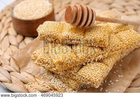 Delicious Sesame Kozinaki Bars And Wooden Dipper On Wicker Mat, Closeup