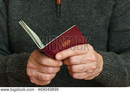 Open German Biometric Passport In Human Hands. Close-up.