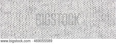 Knitted Gray Background. Large Knitted Fabric With A Pattern. Close-up Of A Knitted Blanket. Horizon