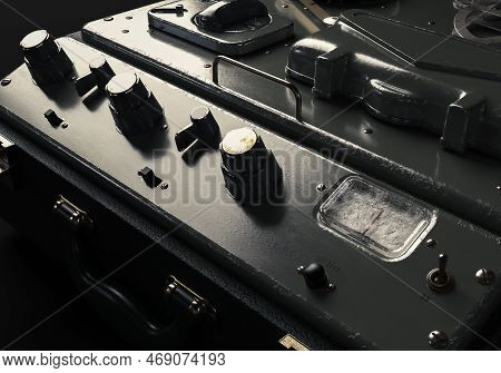 A Vintage Reel-to-reel Analogue Analogue Audio Recorder In A Leather Case On A Dark Moody Studio Bac