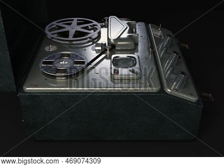A Vintage Reel-to-reel Analogue Analogue Audio Recorder In A Leather Case On A Dark Moody Studio Bac