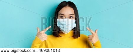 Covid-19, Social Distancing And Pandemic Concept. Close Up Of Young Asian Woman Using Medical Mask D
