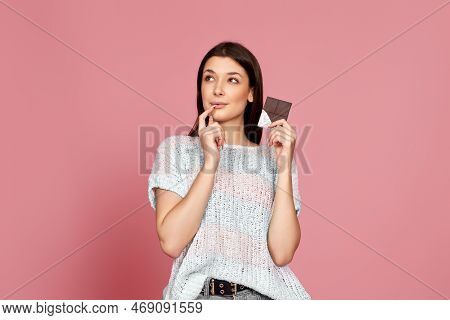 Young Woman In Sweater Holding Chocolate Bar