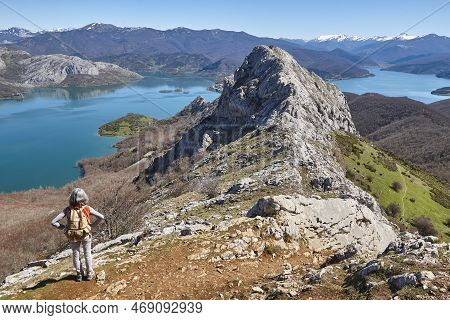 Picturesque Reservoir And Mountain Landscape In Riano. Hikers. Spain