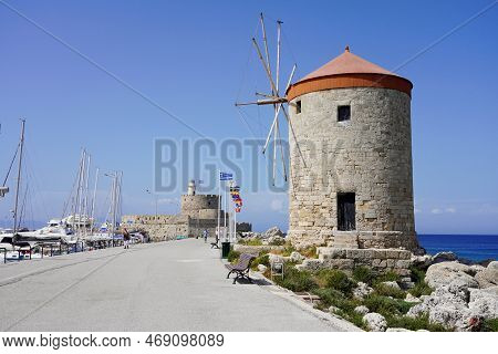 Rhodes, Greece - May 10, 2022: Mandraki Marina And Port With Rhodes Windmills And Fort Of Saint Nich