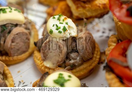French Mini Quiche Pie With Goat Cheese And Traditional French Sausage Andouillette From Troyes In B