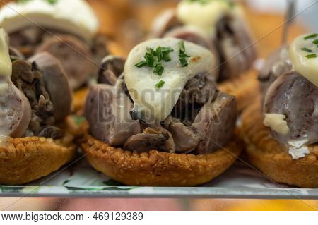 French Mini Quiche Pie With Goat Cheese And Traditional French Sausage Andouillette From Troyes In B