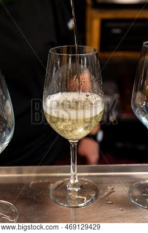 Pouring Of Txakoli Or Chacolí Slightly Sparkling Very Dry White Wine Produced In Spanish Basque Coun