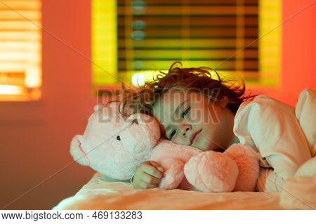 Cute Drowsy Sleepy Child With Toy Teddy Bear In Bed, Bedtime, Childhood And Growth Kids Concept, Clo