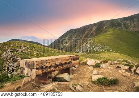 A Bench For A Halt On Mount Furmanov In The Almaty Mountains. View Towards Panorama Peak
