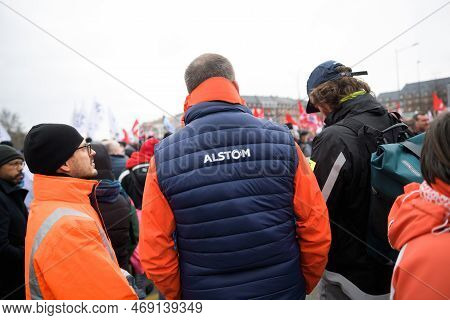 Strasbourg, France - Jan 19, 2023: Man In Alstom Jacket Rear View - Large Crowd At Protest Against T