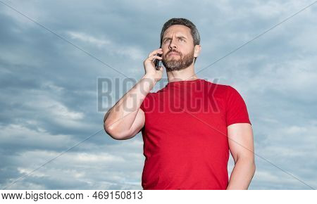 Man Has Phone Talk On Sky Background, Conversation. Man Has Phone Talk Outdoor.