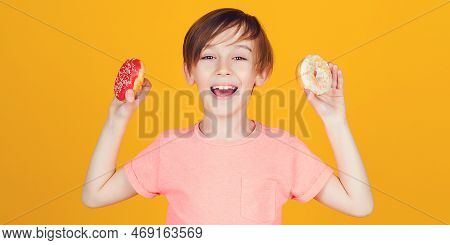 Happy Cute Boy Played With Donuts On Yellow Background Wall. Kid Enjoying Sweets. Birthday Party. Ta