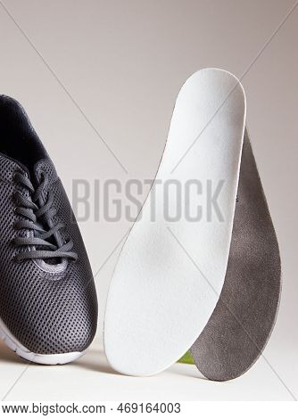 Gray Sport Shoes  With Orthopedic Insoles. Foot Care Products Conception.