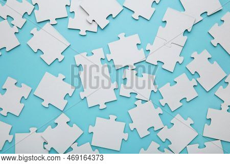 Close-up Of A Pile Of Uncompleted Elements Of A White Puzzle. A Huge Number Of Rectangular Pieces Fr