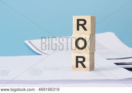 Wooden Cubes With Text Ror - Rate Of Return - On Business Document.