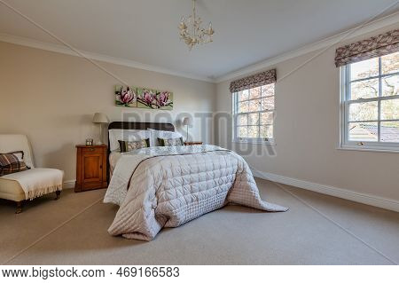 Quy, Cambridgeshire, England - December 10 2014: Furnished Luxury Bedroom With Sidetable And Chair.