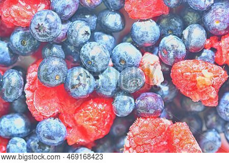 Frozen Fresh Blueberries And Raspberries, Close-up. Close-up View Of Bilberries And Raspberries. Tex