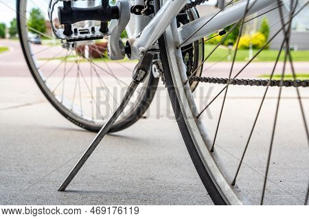 Kick Stand Holding Up A Peddle Bike With Blurred Tire In Background
