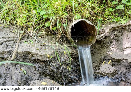 Water Flowing From The Open Outlet Of A Metal Agriculture Drainage Tile
