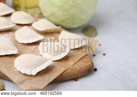 Raw Dumplings (varenyky) With Tasty Filling On Light Grey Table, Closeup. Space For Text