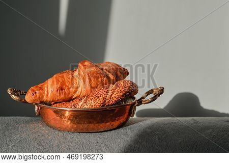 Fresh Pastries For Breakfast, Croissant And Turkish Bagel With Sesame Seeds - Simit In A Copper Tray
