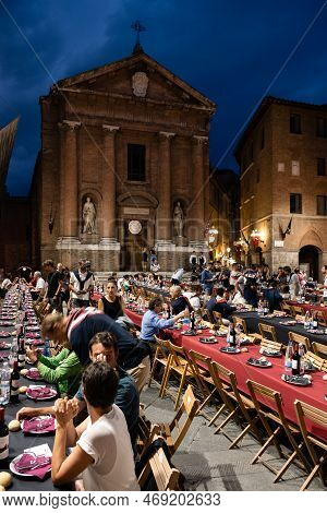 Siena, Italy - August 15 2022: The Grand Contrada Dinner Of The Civetta Or Little Owl Contrada On Th