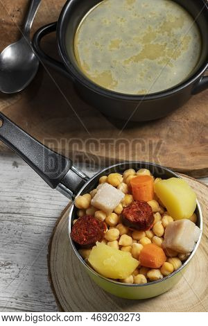 Cooked (cocido, Guiso) Stew, Chickpeas With Chorizo, Bacon, Carrot And Potato In Green Saucepan, Bla