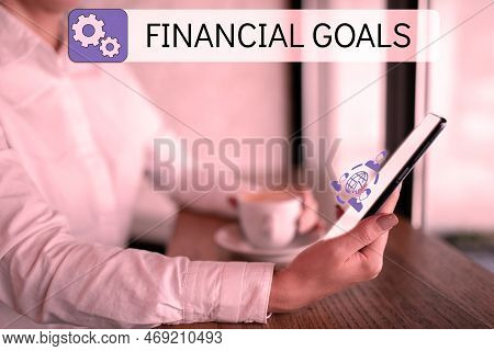 Writing Displaying Text Financial Goals. Word Written On Targets Usually Driven By Specific Future F