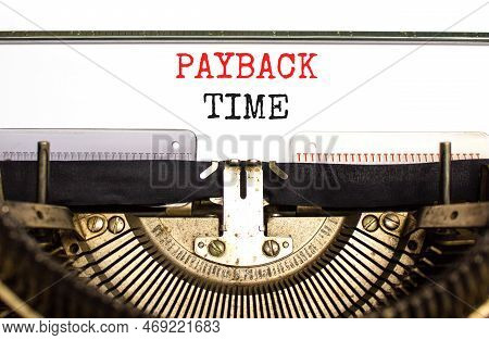 Payback Time Symbol. Concept Words Payback Time Typed On Old Retro Typewriter. Beautiful White Backg