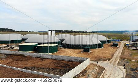 Biogas. Aerial View Of A Biogas Plant And A Farm In Green Fields. Renewable Energy From Biomass. Mod