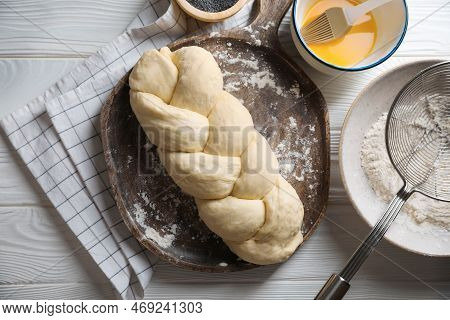 Homemade Braided Bread And Ingredients On White Wooden Table, Flat Lay. Cooking Traditional Shabbat 