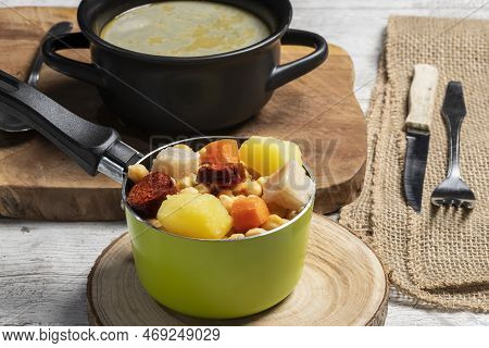 Cooked (cocido, Guiso) Stew, Chickpeas With Chorizo, Bacon, Carrot And Potato In Green Saucepan, Bla
