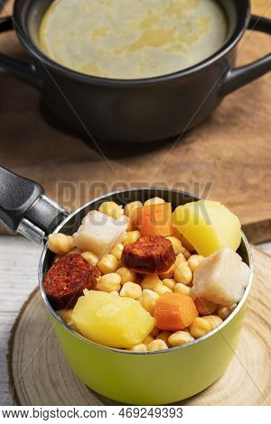 Cooked (cocido, Guiso) Stew, Chickpeas With Chorizo, Bacon, Carrot And Potato In Green Saucepan, Bla