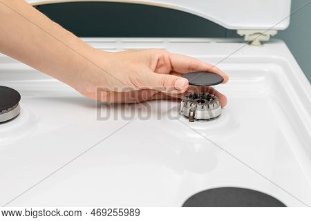 Man Repairing Gas Stove In The Kitchen. Woman Washing The Stove In The Kitchen. Gas Stove. Gas-burne