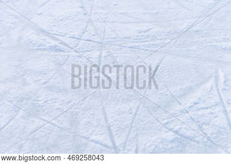 Ice Texture Close Up. Skating Rink Covered With Snow. Skate Tracks In The Snow