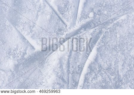 Ice Texture Close Up. Skating Rink Covered With Snow. Skate Tracks In The Snow