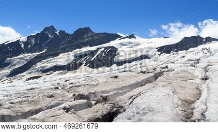 Mountain Grossglockner Panorama And Glacier Pasterze With Icefall Hufeisenbruch And Crevasses In Glo
