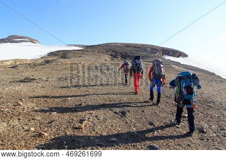 Group Of People Hiking And Mountain Snow Panorama In Glockner Group, Austria