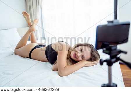 Young Sexy Woman Posing In Front Of Camera And Working As Webcam Model