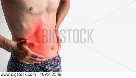Asian Young Man Suffering From Abdominal Pain. It Can Be Caused By Stomach Ache, Enteritis, Colitis,