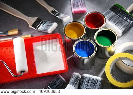 Paintbrushes Of Different Size And Paint Cans