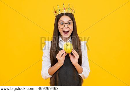 Teen Child In Queen Crown Hold Apple Isolated On Yellow Background. Princess Girl In Tiara. Teenage 